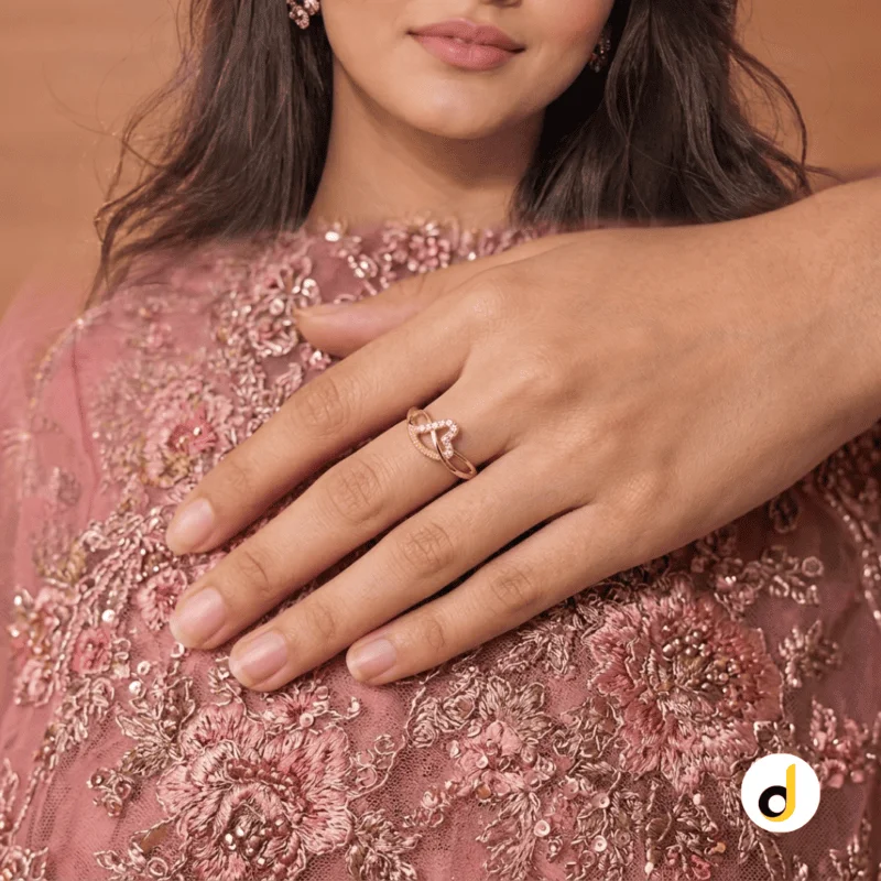 Double heart gold ring for women with intertwined design and sparkling stone accents